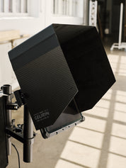 Carbon fibre sun shade hood for iPad Pro and iPad Pro cage cheeseplate mounting system with 3/8"-16 screw holes for accessories including v-lock battery and NATO rail with magic arm.
